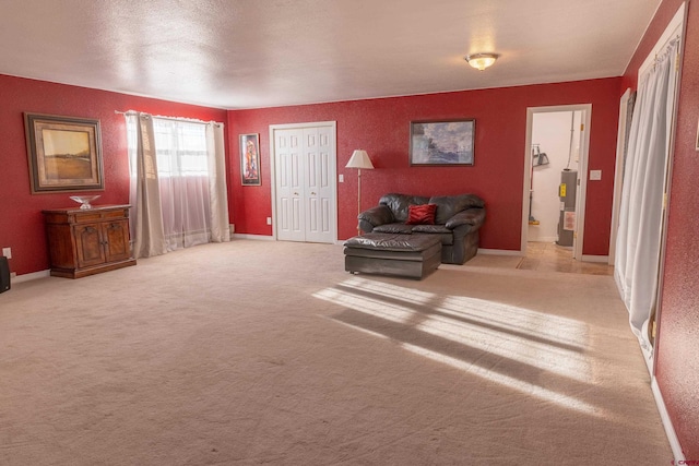 living room featuring water heater, carpet, and baseboards