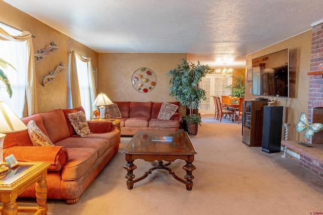 carpeted living room with an inviting chandelier, brick wall, a textured ceiling, and a brick fireplace