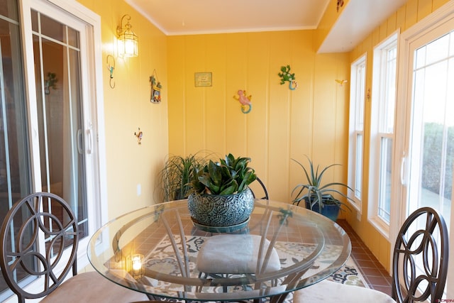 dining space with a wealth of natural light and ornamental molding