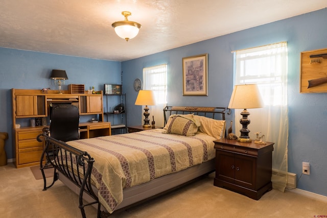 bedroom featuring light colored carpet, multiple windows, and baseboards