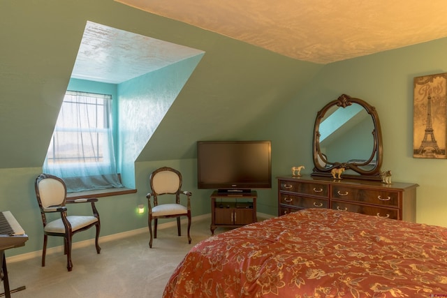 bedroom with carpet flooring, vaulted ceiling, and baseboards