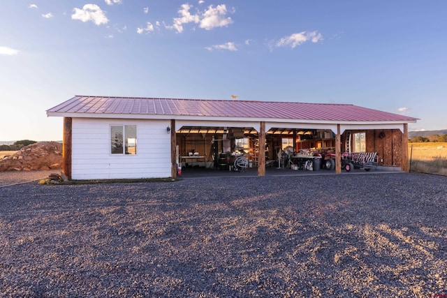 garage at dusk featuring a carport