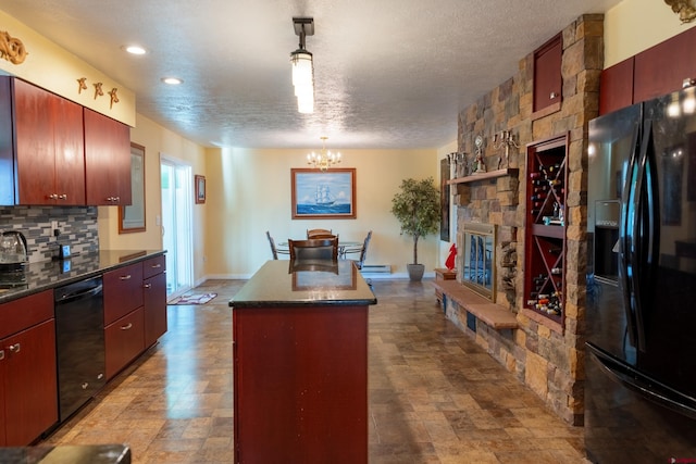 kitchen with a fireplace, a center island, black appliances, tasteful backsplash, and dark countertops