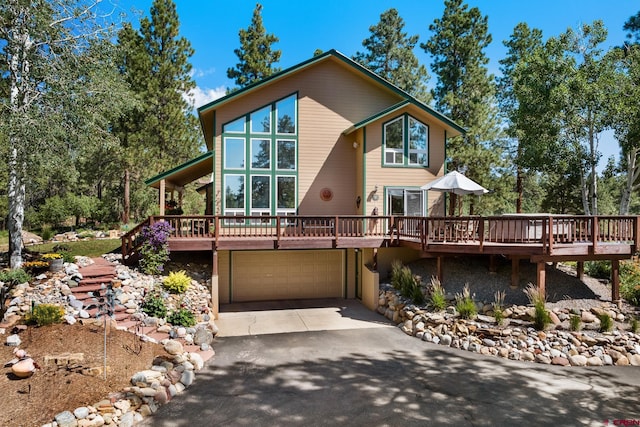 view of front of property with a deck and a garage