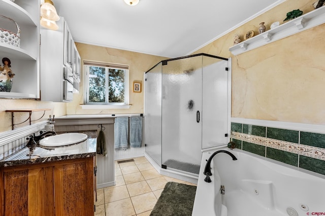 bathroom with tile patterned floors, vanity, crown molding, and shower with separate bathtub