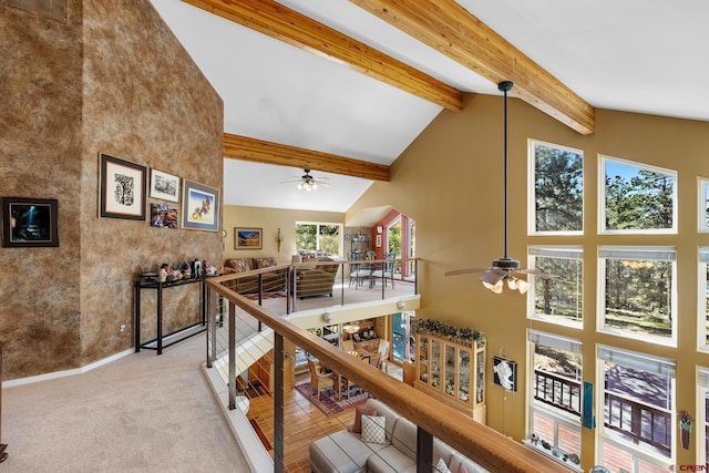 hall with light carpet, beam ceiling, and high vaulted ceiling