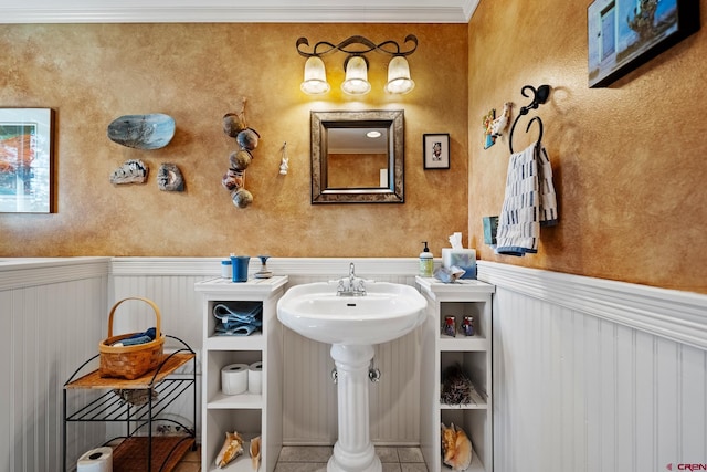 bathroom featuring tile patterned flooring and ornamental molding