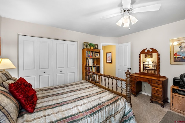 bedroom featuring a closet, light colored carpet, and ceiling fan