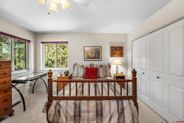 bedroom featuring light carpet, a closet, and ceiling fan