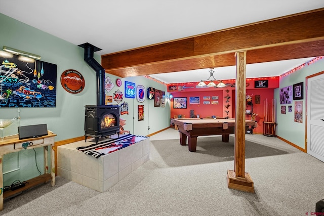 rec room with beamed ceiling, a wood stove, carpet floors, and pool table