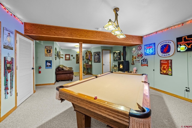 rec room featuring beam ceiling, a wood stove, carpet floors, and billiards