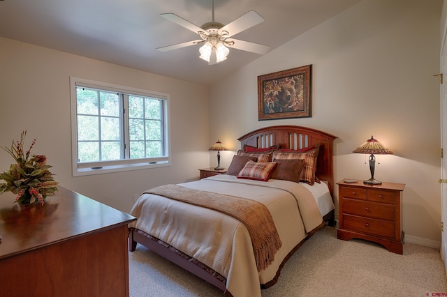 carpeted bedroom with ceiling fan and vaulted ceiling