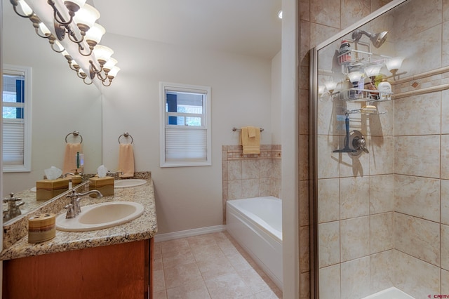 bathroom with tile patterned flooring, vanity, an inviting chandelier, and plus walk in shower