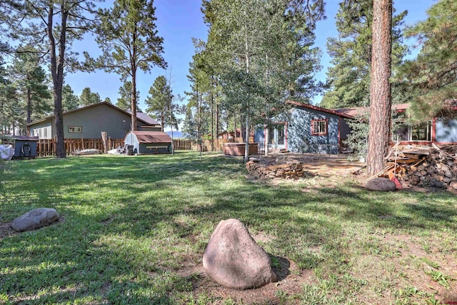 view of yard with a storage unit and fence