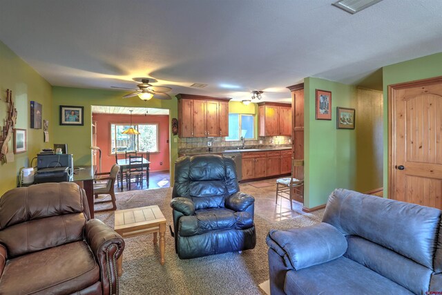 tiled living room featuring sink and ceiling fan