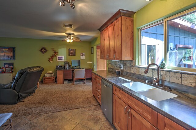 kitchen with light tile patterned flooring, dishwasher, a healthy amount of sunlight, and tasteful backsplash