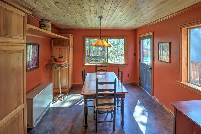 dining space featuring crown molding and wood ceiling