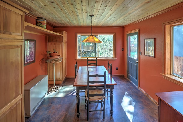 dining room featuring finished concrete flooring, wood ceiling, ornamental molding, and baseboards