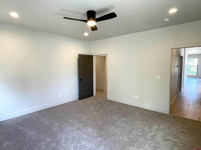carpeted spare room featuring a ceiling fan, recessed lighting, and baseboards