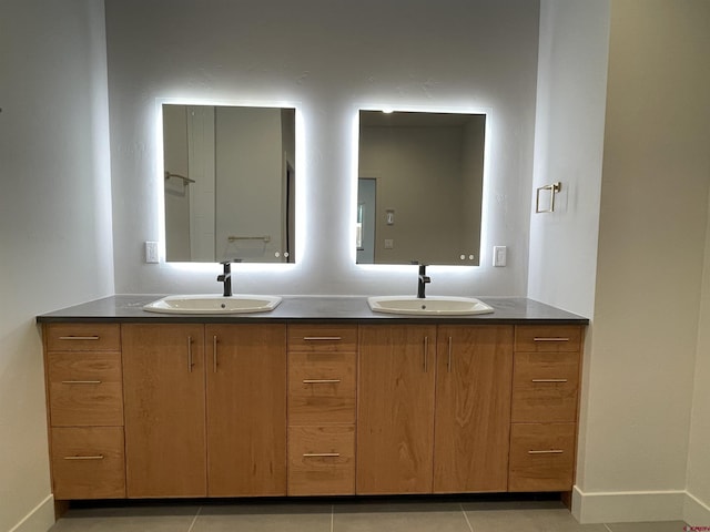 bathroom featuring double vanity, a sink, and tile patterned floors