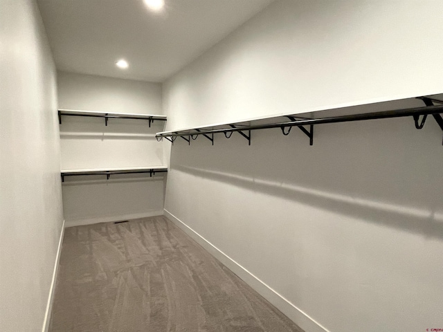 walk in closet with carpet