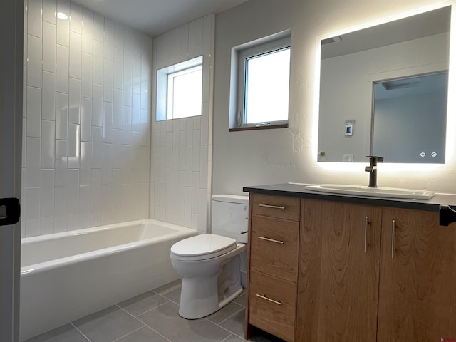 bathroom featuring toilet, shower / bathtub combination, vanity, and tile patterned floors