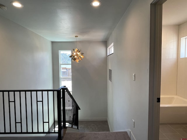 stairway featuring a chandelier, tile patterned flooring, recessed lighting, visible vents, and baseboards