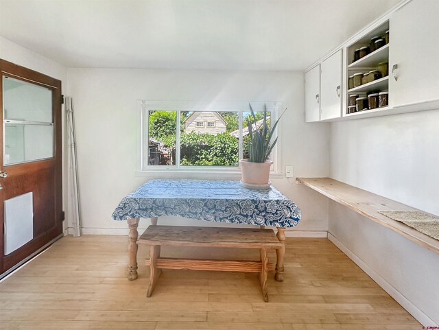 kitchen with sink, white cabinetry, light wood-type flooring, and stainless steel appliances