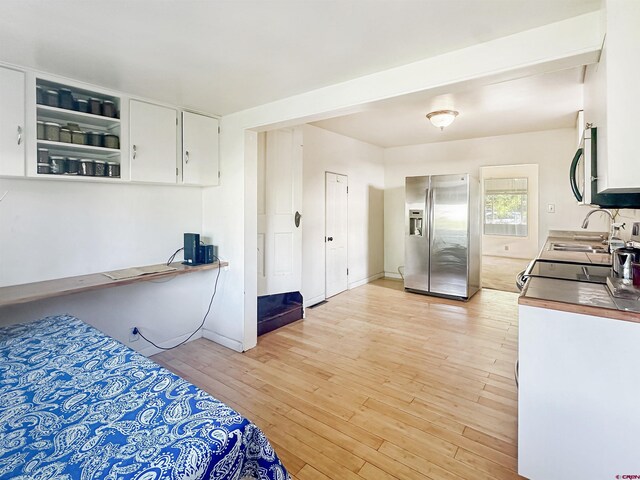 kitchen featuring white cabinetry, light hardwood / wood-style floors, appliances with stainless steel finishes, and sink