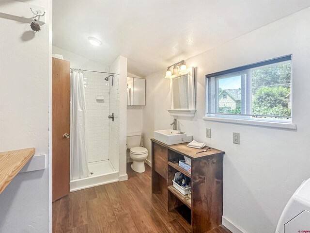 bathroom featuring vanity, toilet, a shower with shower curtain, and hardwood / wood-style floors