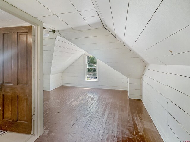 bonus room featuring vaulted ceiling and hardwood / wood-style floors