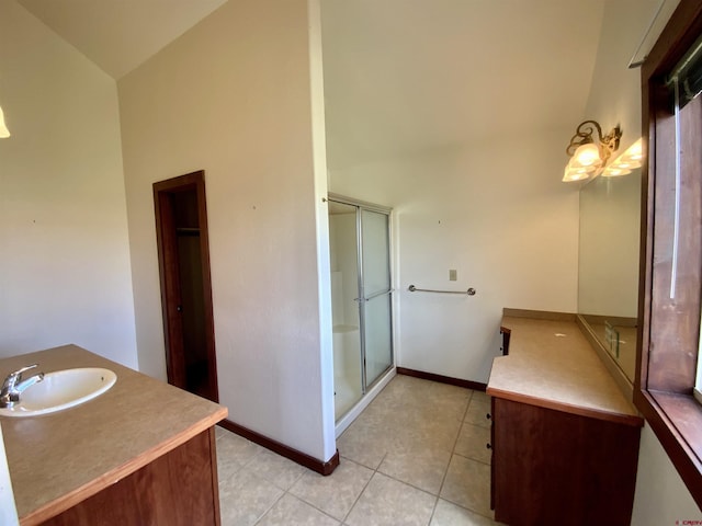 bathroom featuring tile patterned floors, vanity, and lofted ceiling