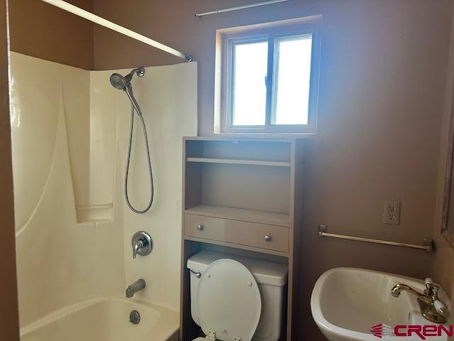 full bathroom featuring shower / bathing tub combination, toilet, and sink