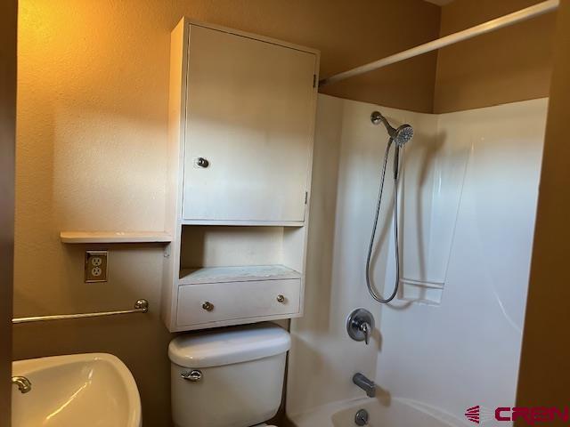 full bathroom featuring  shower combination, toilet, and sink