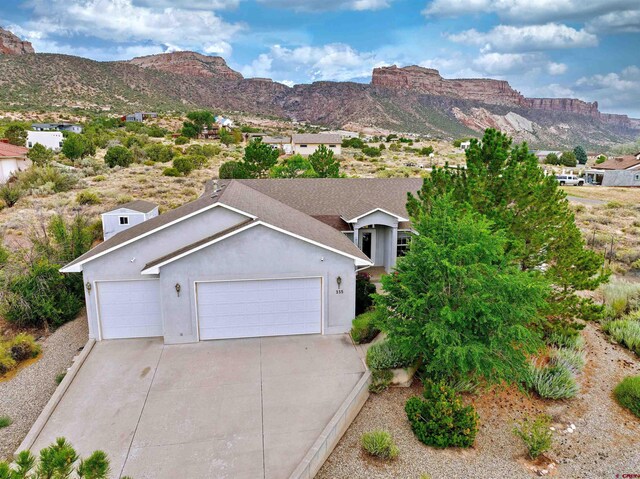 view of front facade with a mountain view and a garage