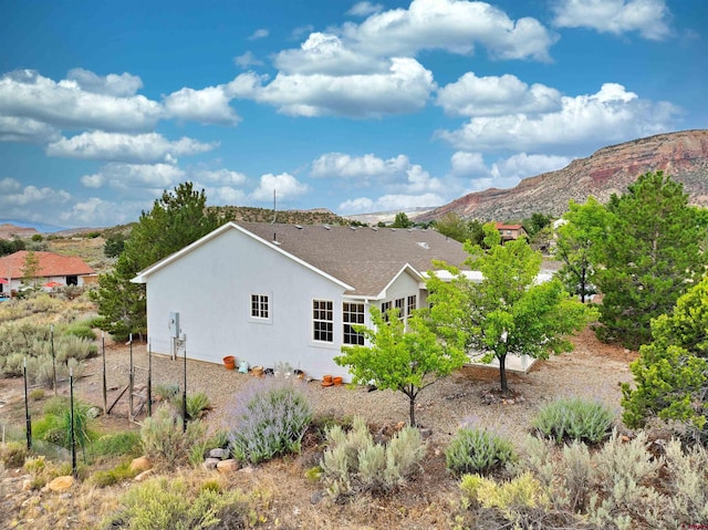 rear view of property featuring a mountain view