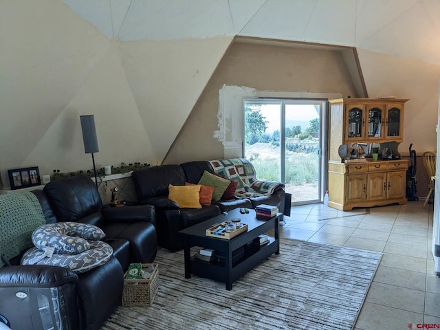 living room with light tile patterned flooring and vaulted ceiling