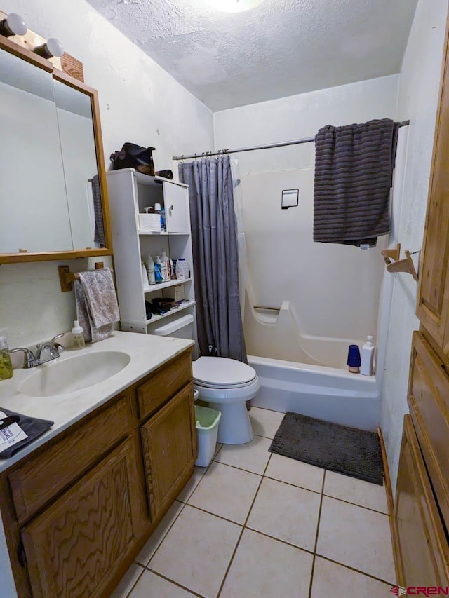 full bathroom with shower / bath combo with shower curtain, tile patterned flooring, a textured ceiling, toilet, and vanity