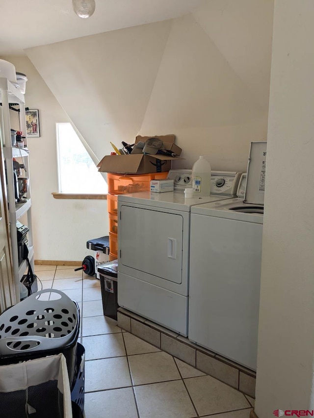 laundry area with light tile patterned flooring and washer and clothes dryer