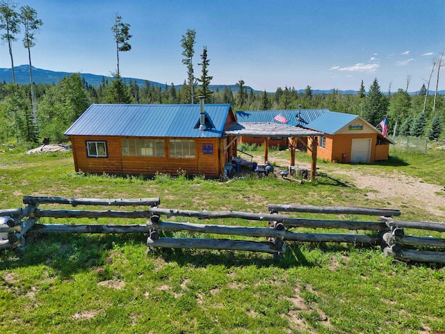 19958 Fs 327th Loop, Mancos, CO 81328 - view of front of home featuring a mountain view, metal roof, dirt driveway, and fence