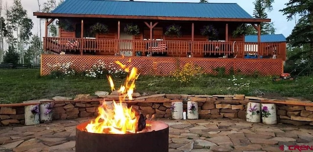 19958 Fs 327th Loop, Mancos, CO 81328 - back of house with metal roof, covered porch, and an outdoor fire pit