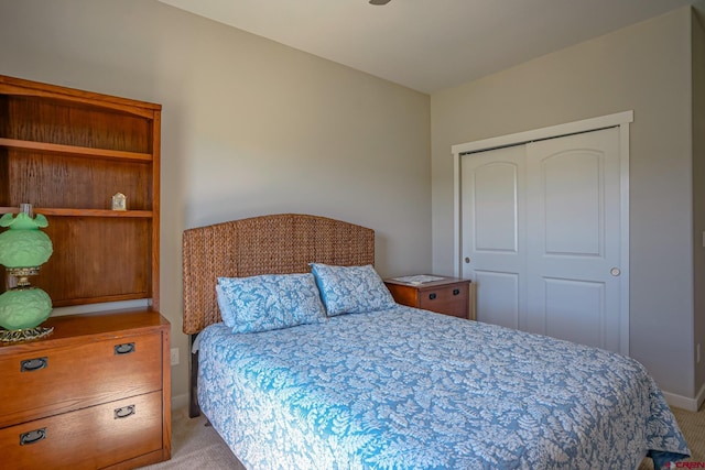 bedroom featuring a closet and light carpet