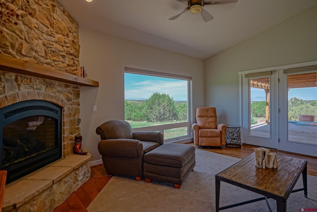 living room with lofted ceiling, ceiling fan, hardwood / wood-style flooring, and plenty of natural light