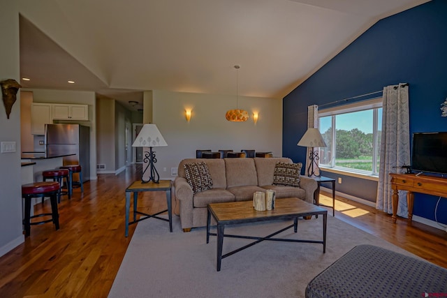 living room with lofted ceiling and wood-type flooring