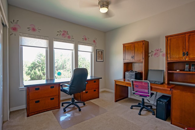 home office with ceiling fan, a wealth of natural light, and light carpet