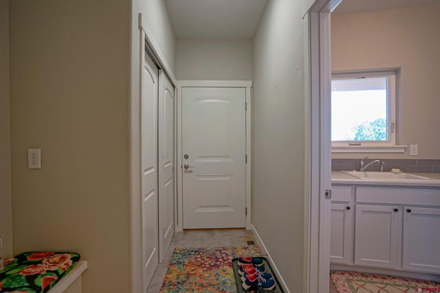 hall with sink and light tile patterned floors