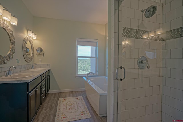 bathroom featuring wood-type flooring, vanity, and separate shower and tub