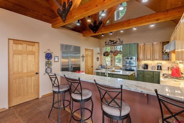 kitchen featuring stainless steel appliances, a kitchen breakfast bar, and tasteful backsplash