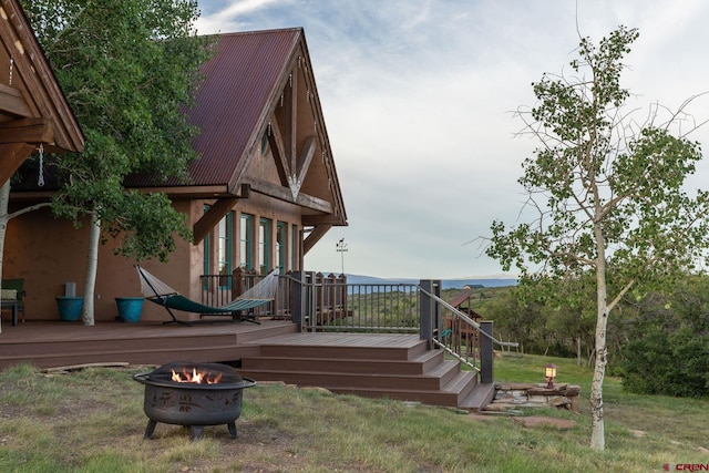 view of play area with a fire pit and a wooden deck