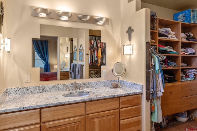 bathroom with tile patterned flooring and vanity